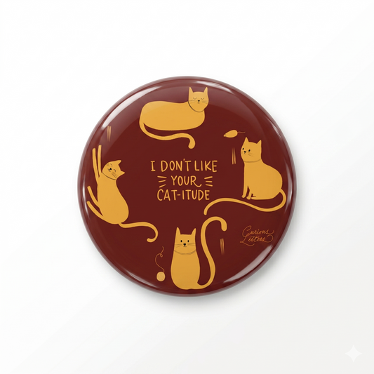 A 2-in-1 "Cat-itude" bottle-opener and fridge magnet, with cats with attitude, for cat lovers, art by Curious Letters. 58 mm diameter and sturdy metal body. 